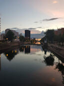 Using AI to monitor urban heat impacts on Bucharest’s river. Cityscape reflection on a calm river at dusk.